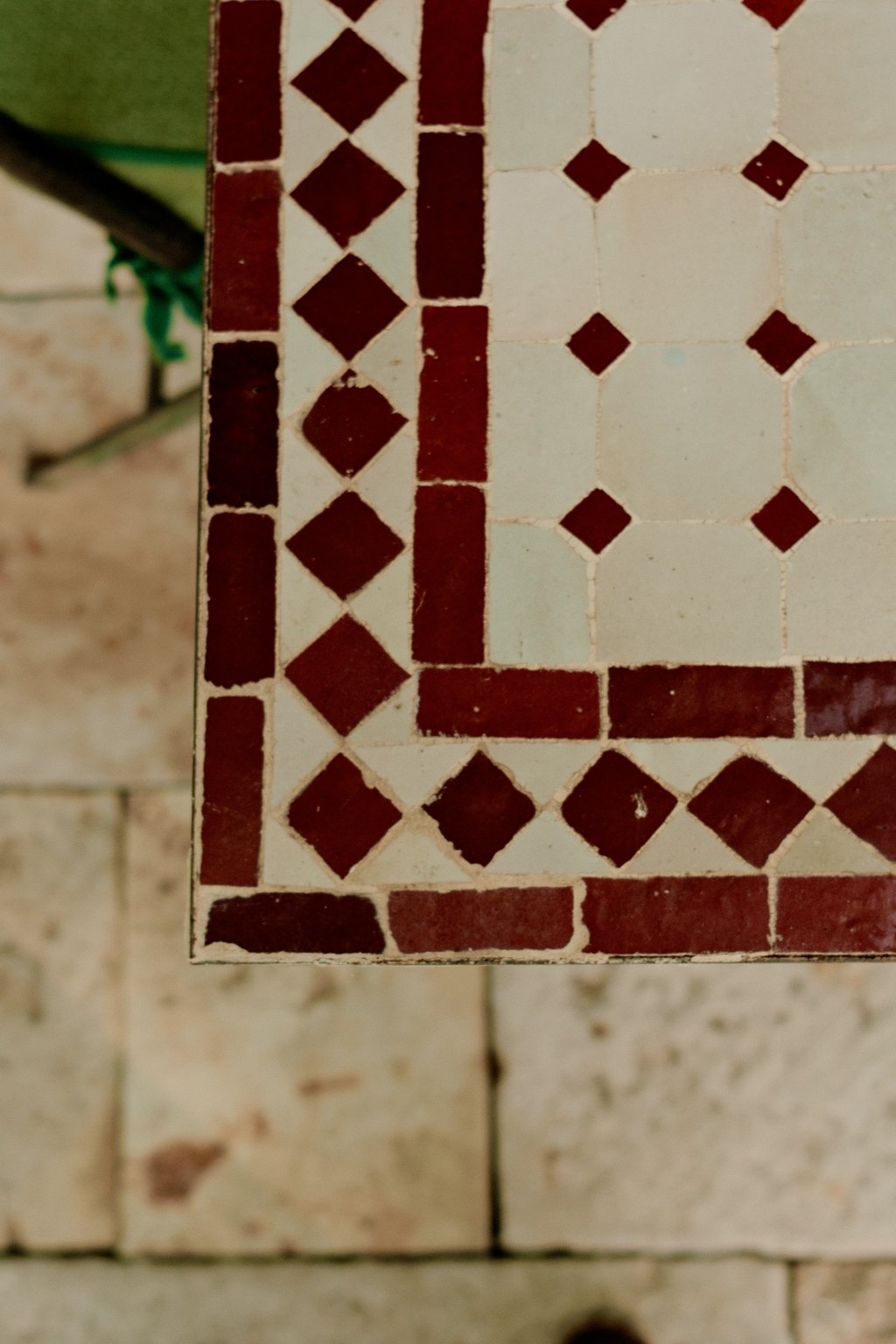 Oxblood and white zellige tiles set into pale stone